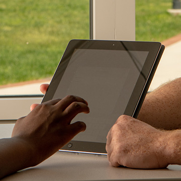 Ohio Information Technologies worker helping with a tablet issue.