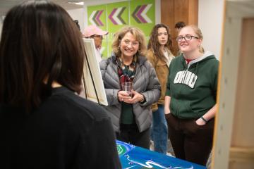 An OHIO student is shown with her mother at the Pop Up Market in Alden Library during Moms Weekend 2024.
