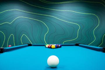 A pool table is shown in the new student engagement space in the Baker University Center
