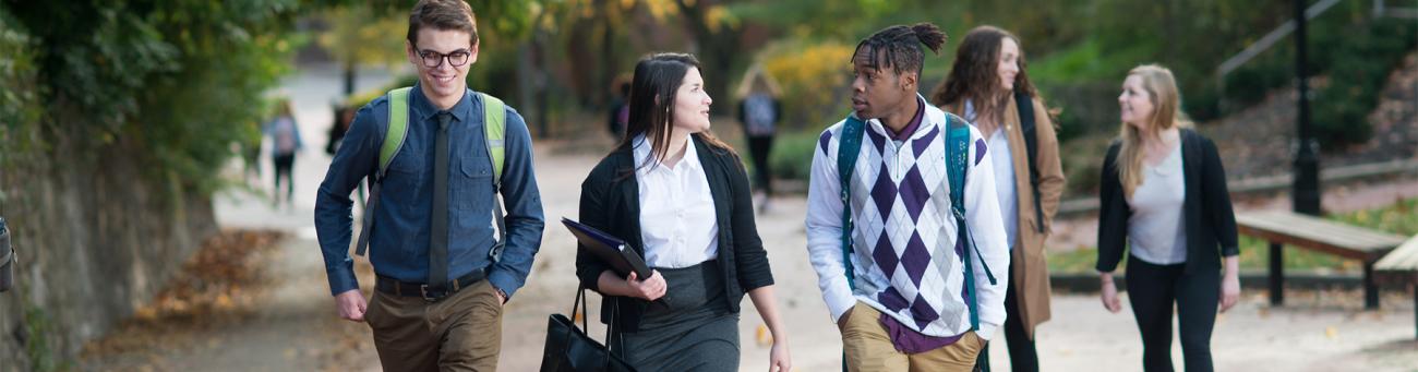 Three students talk while walk up Mortan Hill.