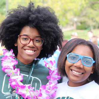 Two students smile at an event